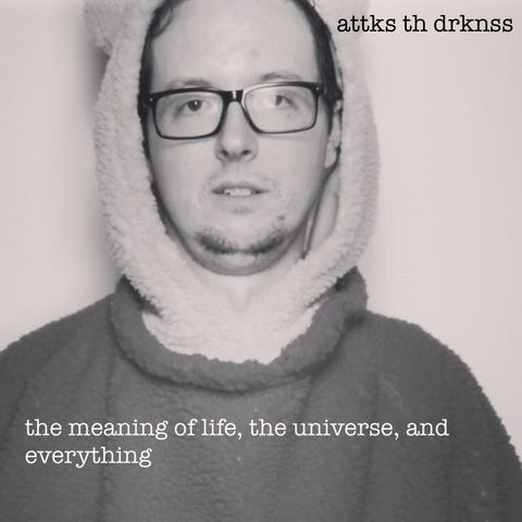 A black and white picture of me wearing a bear suit with my black rimmed glasses.